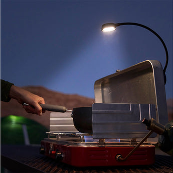 Nite Ize attached to and shining down on a grill