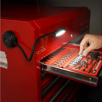 Red toolbox with open drawer displaying tools, illuminated by the Flex Light