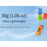 Orange device with balloons against a blue sky background, highlighting its ultra-lightweight nature.