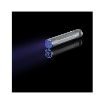 nite ize inova x5 uv flashlight on a black background