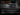 Black flashlight on a textured surface with compatibility information displayed.