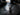 Black flashlight with USB Type-C charging cable on a reflective surface
