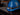 Blue hard hat with a Fenix headlamp/flashlight on a dark surface