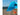 Blue beach tent on a sandy beach with a clear sky tethered to an orange ground anchor