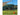 Orange tent stake holding down a tent with mountain in the background